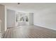 Living room featuring gray flooring, neutral paint, bright bay windows with security bars, and plenty of light at 310 Wolf Downs Way, Atlanta, GA 30349