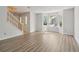 Spacious living room with hardwood floors, staircase, and bay windows allowing for plenty of natural light at 310 Wolf Downs Way, Atlanta, GA 30349