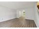 Spacious living room featuring modern flooring and neutral paint, leading to the staircase at 310 Wolf Downs Way, Atlanta, GA 30349