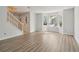 Bright living room with hardwood floors, staircase, and a bay window with decorative ironwork at 310 Wolf Downs Way, Atlanta, GA 30349