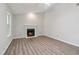 Open living room with fireplace, vaulted ceiling, and modern flooring at 310 Wolf Downs Way, Atlanta, GA 30349