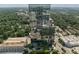 Elevated perspective of a towering high-rise, set against the backdrop of tree-filled neighborhoods and a vibrant cityscape at 3630 Peachtree Ne Rd # 2408, Atlanta, GA 30326