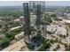 Stunning aerial view of a modern high-rise building surrounded by lush greenery and cityscape showcasing urban elegance at 3630 Peachtree Ne Rd # 2408, Atlanta, GA 30326