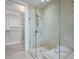 Well-lit bathroom features glass shower and open doorway that leads to walk-in closet, providing convenient access to storage at 3630 Peachtree Ne Rd # 2408, Atlanta, GA 30326