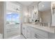 Spacious bathroom featuring double vanity, bright lighting, and a view into the bedroom at 3630 Peachtree Ne Rd # 2408, Atlanta, GA 30326