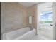 Bathroom featuring a deep soaking tub and views of the bedroom at 3630 Peachtree Ne Rd # 2408, Atlanta, GA 30326