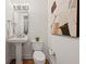 Elegant powder room boasts a pedestal sink, modern lighting, and beautiful artwork, blending style and functionality at 3630 Peachtree Ne Rd # 2408, Atlanta, GA 30326