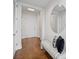 Bright entryway showcasing hardwood floors, a bench, and a decorative mirror, creating a modern, clean aesthetic at 3630 Peachtree Ne Rd # 2408, Atlanta, GA 30326
