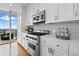 Modern kitchen featuring stainless steel appliances, white cabinetry and view to the balcony at 3630 Peachtree Ne Rd # 2408, Atlanta, GA 30326