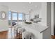 Modern kitchen featuring white cabinets, a spacious island with seating, and contemporary stainless steel appliances at 3630 Peachtree Ne Rd # 2408, Atlanta, GA 30326
