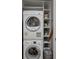 Efficient laundry area equipped with stacked washer and dryer plus additional storage shelving for added convenience at 3630 Peachtree Ne Rd # 2408, Atlanta, GA 30326