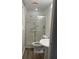 A clean bathroom with a glass-doored shower and a pedestal sink at 3785 Somerset Sw Dr, Marietta, GA 30064