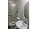 Bathroom with a sliding glass door shower, toilet, and decorative mirror at 3785 Somerset Sw Dr, Marietta, GA 30064