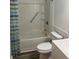 Clean, white bathroom featuring a shower-tub combo, toilet, and wood-look flooring at 3785 Somerset Sw Dr, Marietta, GA 30064