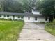 Ranch-style home features a long, single-story layout with a concrete driveway surrounded by trees at 3785 Somerset Sw Dr, Marietta, GA 30064