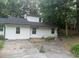 Charming home exterior with mature trees and a concrete driveway at 3785 Somerset Sw Dr, Marietta, GA 30064