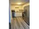 Modern kitchen featuring stainless steel appliances, white cabinets, and light wood floors at 3785 Somerset Sw Dr, Marietta, GA 30064