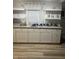 Bright eat-in kitchen featuring white cabinetry, countertops, and shelves at 3785 Somerset Sw Dr, Marietta, GA 30064