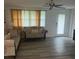 Living room area with neutral-toned furniture, light wood floors, and a ceiling fan at 3785 Somerset Sw Dr, Marietta, GA 30064