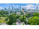 Expansive city skyline view from a modern home, surrounded by trees and vibrant green spaces at 536 Highland Ne Ave # A, Atlanta, GA 30312