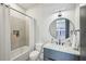 Modern bathroom with shower/tub combo, quartz countertops, and round mirror at 536 Highland Ne Ave # A, Atlanta, GA 30312