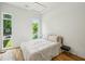 Bright bedroom with large windows, hardwood floors, and modern light fixture at 536 Highland Ne Ave # A, Atlanta, GA 30312
