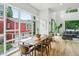 Sun-filled dining room with modern lighting and large windows overlooking a lush yard at 536 Highland Ne Ave # A, Atlanta, GA 30312