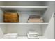 Clean white storage shelves with folded towels and a wooden box at 536 Highland Ne Ave # A, Atlanta, GA 30312