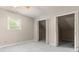 Bedroom featuring large closets, light carpet, and a window at 233 Oakridge Se Dr, Cartersville, GA 30121