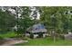 Aerial view of a charming home with a wraparound porch, lush landscaping, and a well-maintained lawn at 233 Oakridge Se Dr, Cartersville, GA 30121