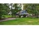 Aerial view of a charming home with a wraparound porch, lush landscaping, and a well-maintained lawn at 233 Oakridge Se Dr, Cartersville, GA 30121