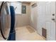 Laundry room with side by side washer and dryer, access door and tile flooring at 233 Oakridge Se Dr, Cartersville, GA 30121