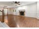Spacious living room with hardwood floors, a stone fireplace, and a ceiling fan at 233 Oakridge Se Dr, Cartersville, GA 30121