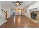 Large living room with hardwood flooring, stone fireplace, and a staircase at 233 Oakridge Se Dr, Cartersville, GA 30121