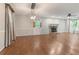 Open living room with hardwood floors, a stone fireplace, and natural light from windows at 233 Oakridge Se Dr, Cartersville, GA 30121