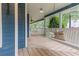 Inviting covered porch with a swing, white railing, and blue trim offers a relaxing outdoor space at 233 Oakridge Se Dr, Cartersville, GA 30121