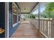 Expansive covered porch with a swing, white railing, and wooden flooring offers ample space to relax at 233 Oakridge Se Dr, Cartersville, GA 30121