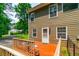 Cozy deck features a table, chairs, and access to the backyard with green lawn at 2430 Tribble Creek Cv, Grayson, GA 30017