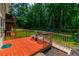 Relaxing back deck with seating and stairs descending to the backyard at 2430 Tribble Creek Cv, Grayson, GA 30017