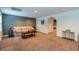 A finished basement with couch, neutral walls, and arched entryway at 2430 Tribble Creek Cv, Grayson, GA 30017