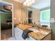 Bathroom with double sinks, granite countertops, white cabinetry, neutral wall paint and large mirror at 2430 Tribble Creek Cv, Grayson, GA 30017