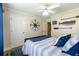 Bedroom with queen bed, nautical decor, and a bright window at 2430 Tribble Creek Cv, Grayson, GA 30017