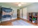Bright bedroom with light blue walls, hardwood floors, and ceiling fan at 2430 Tribble Creek Cv, Grayson, GA 30017