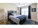 Nautical themed bedroom with a queen bed, ceiling fan, and a bright window at 2430 Tribble Creek Cv, Grayson, GA 30017