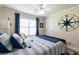 Nautical themed bedroom with a queen bed, ceiling fan, and a bright window at 2430 Tribble Creek Cv, Grayson, GA 30017