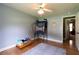 Bright bedroom with light blue walls, hardwood floors, and ceiling fan at 2430 Tribble Creek Cv, Grayson, GA 30017