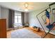 Inviting bedroom with hardwood floors, a ceiling fan, and a bench under the bright window at 2430 Tribble Creek Cv, Grayson, GA 30017