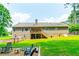 Spacious backyard of the home with a patio and steps leading to the upper deck at 2430 Tribble Creek Cv, Grayson, GA 30017