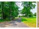 Long driveway leading to the house showcasing the landscaped front yard and mature trees at 2430 Tribble Creek Cv, Grayson, GA 30017