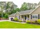 Inviting home features a cozy covered porch, an attached two-car garage, and manicured landscaping at 2430 Tribble Creek Cv, Grayson, GA 30017
